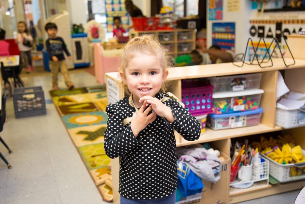 Smiling preschool girl in a polka dot dress